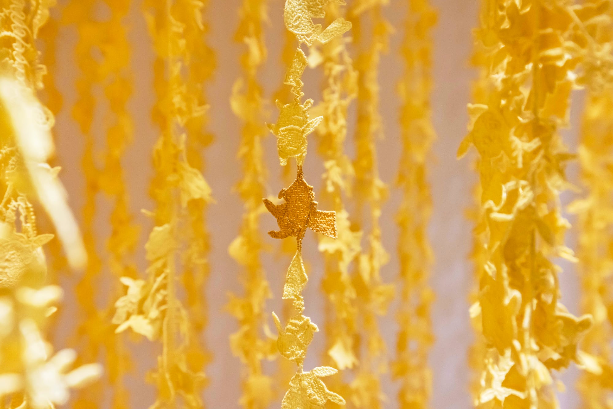 yellow tendrils made of pikachu-shaped pieces of fabric 