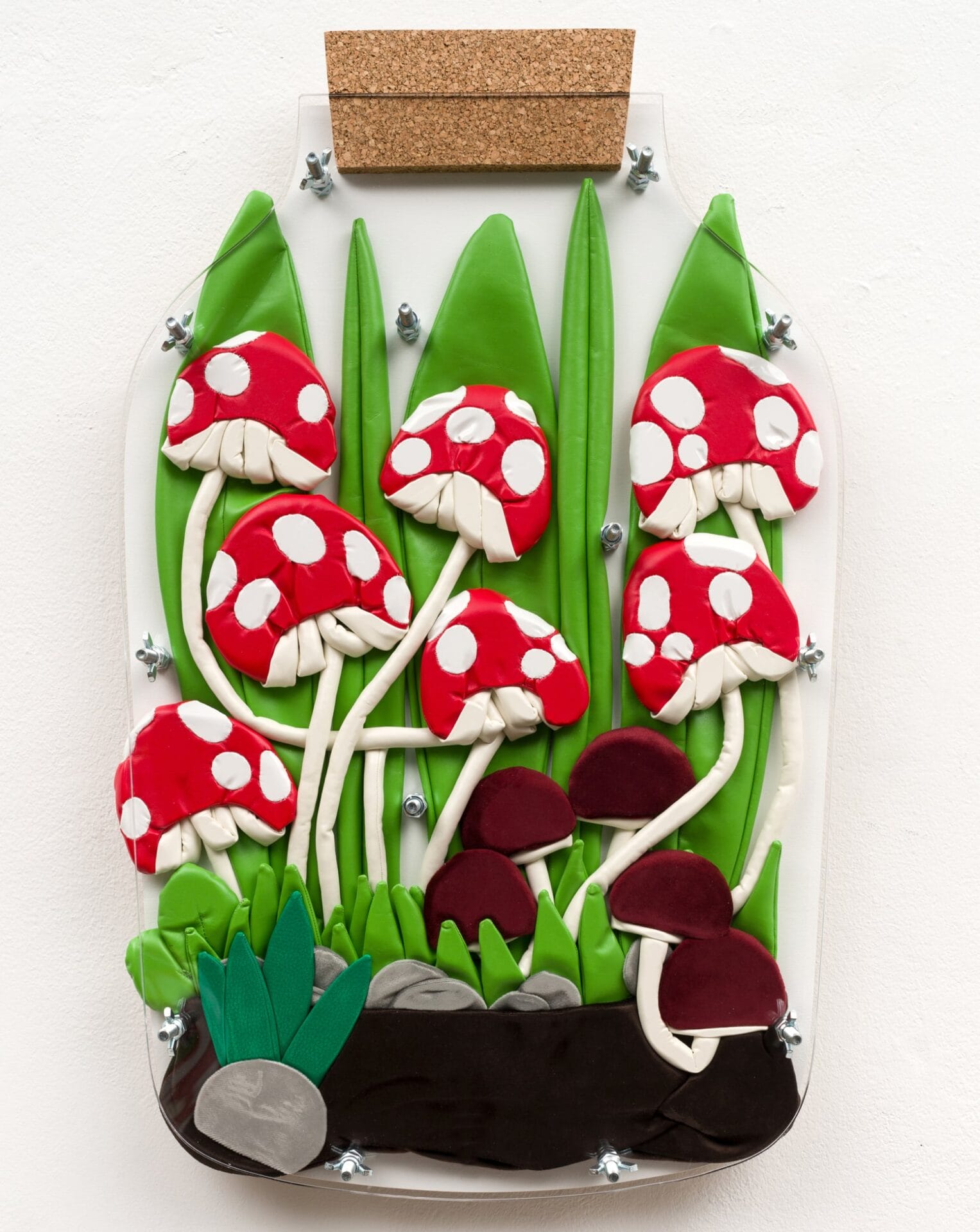 red and white spores sprout in a terrarium