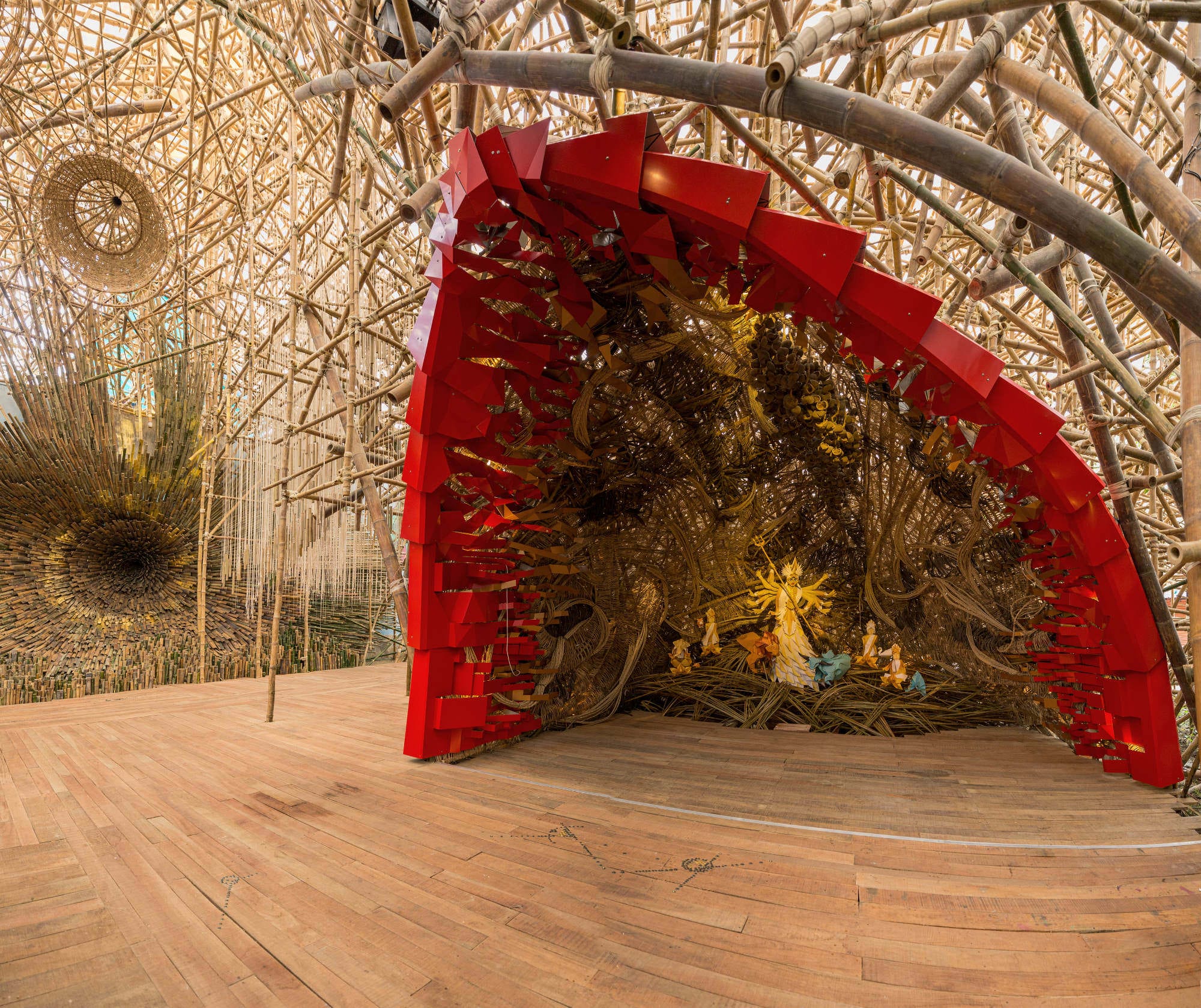 a large bamboo installation with a red shell structure