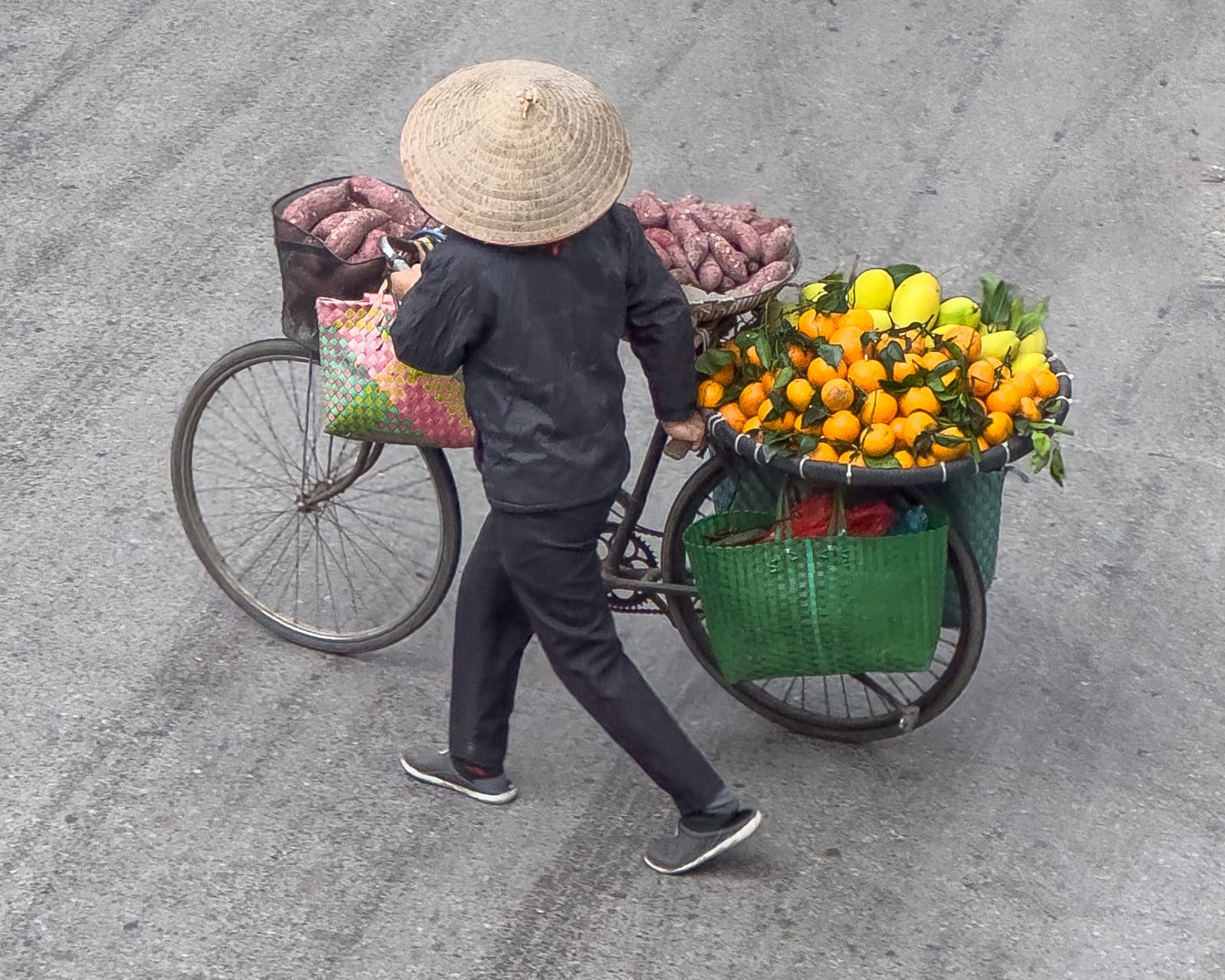 a photo showing a merchant wheeling produce to market