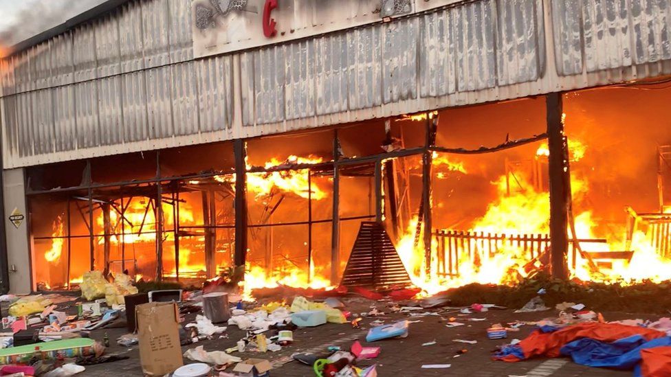 A fire engulfs Campsdrift Park, which houses Makro and China Mall, following protests that have widened into looting in Pietermaritzburg, South Africa, 13 July 2021